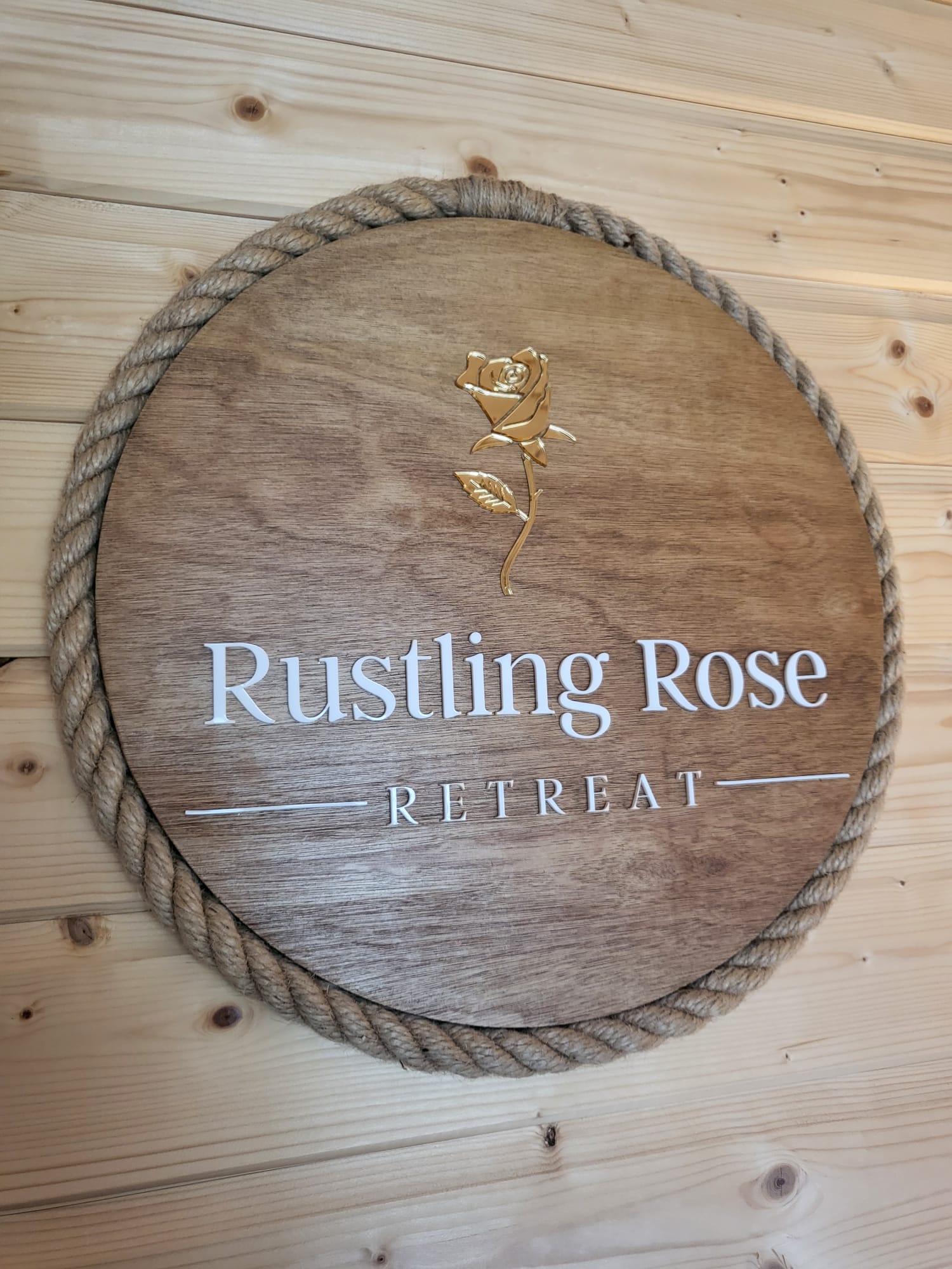 Rustling Rose Retreat logo plaque